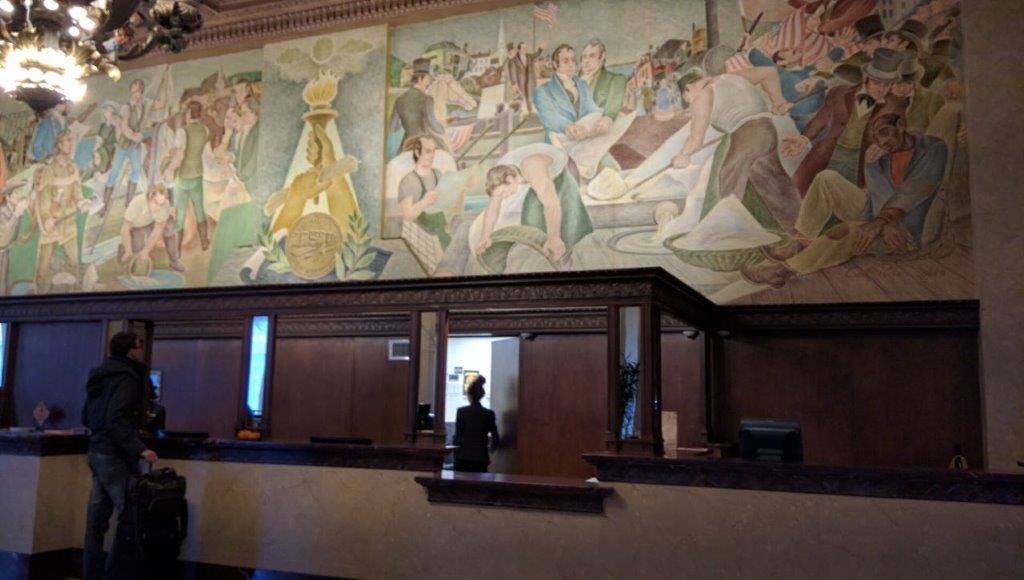 A mural over the reception desk pictures city highlights